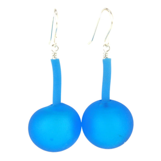 The Aura Earrings in Aqua, featuring handcrafted frosted blue glass beads suspended from flexible tubing with sterling silver hooks, designed for modern elegance and easy wear.