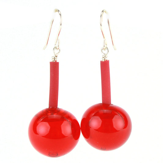 The Aura Earrings in Cherry Red, featuring handcrafted glossy glass beads suspended from flexible tubing with sterling silver hooks, designed for bold elegance and easy wear.