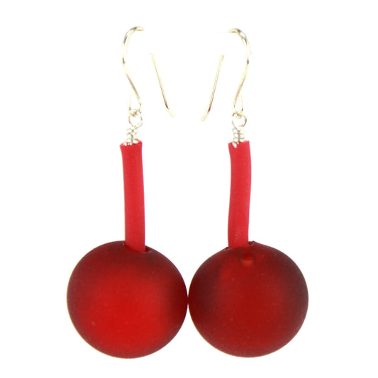 The Aura Earrings in Red, featuring handcrafted frosted glass beads suspended from flexible tubing with sterling silver hooks, designed for bold elegance and easy wear.