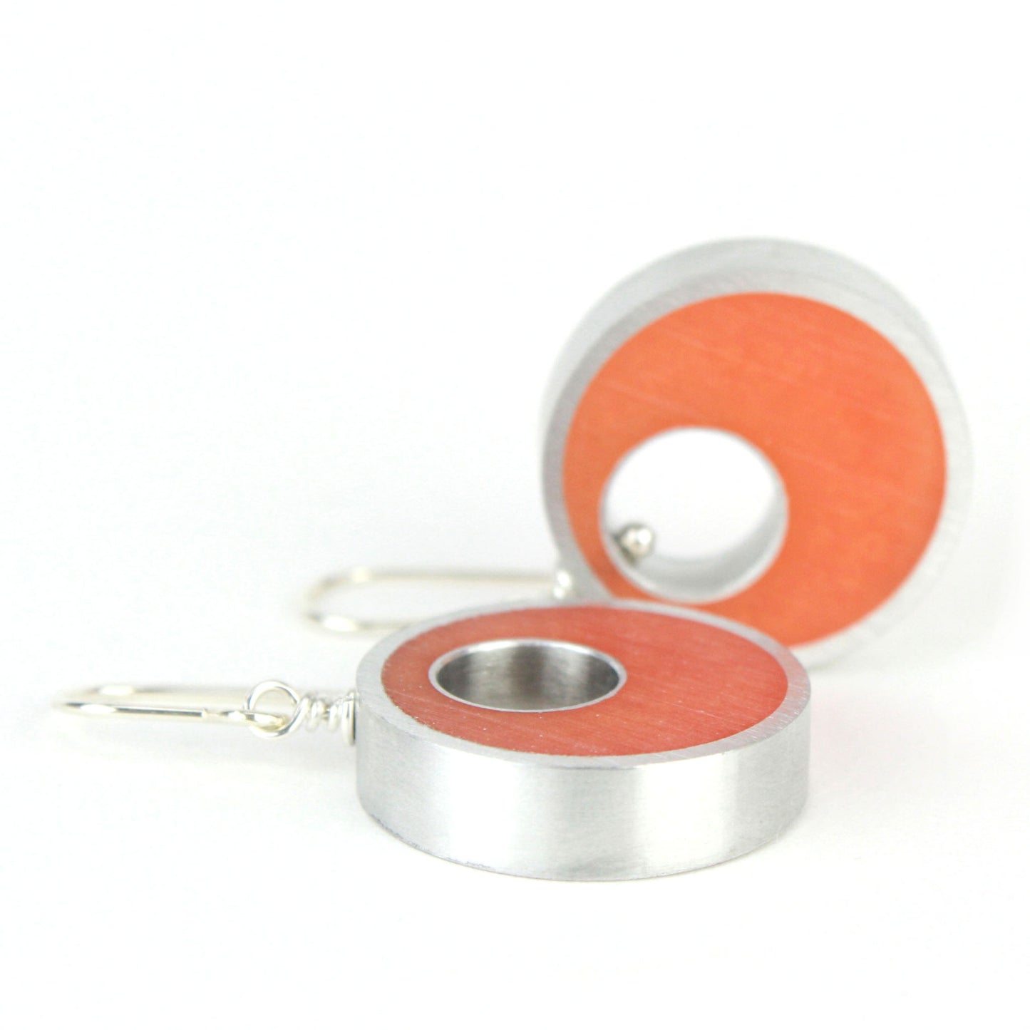 Orange Spotlight Earrings made of eco-resin and salvaged aluminum with sterling silver ear wires, offering lightweight and sustainable elegance.