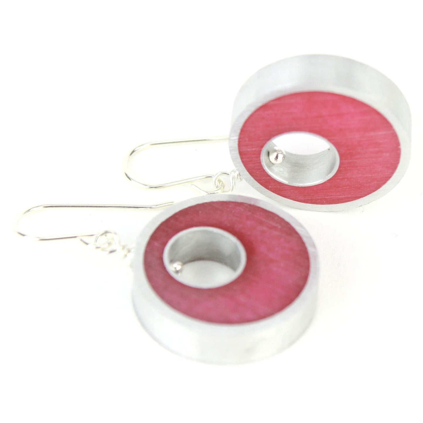 Bright pink Spotlight Earrings made of eco-resin and salvaged aluminum with sterling silver ear wires, offering lightweight and sustainable beauty.