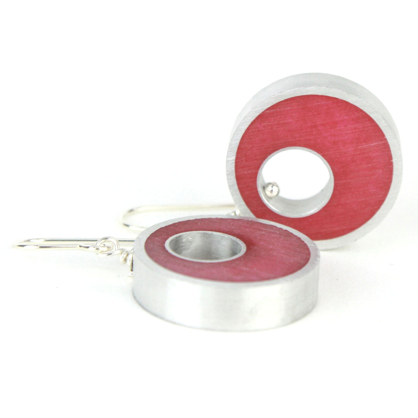 Bright pink Spotlight Earrings made of eco-resin and salvaged aluminum with sterling silver ear wires, offering lightweight and sustainable beauty.