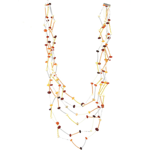 The Fiesta Necklace in amber, ivory and gold. Handcrafted six-strand necklace in amber, ivory, and gold glass beads with handmade lampwork accents and a zig-zag drape.