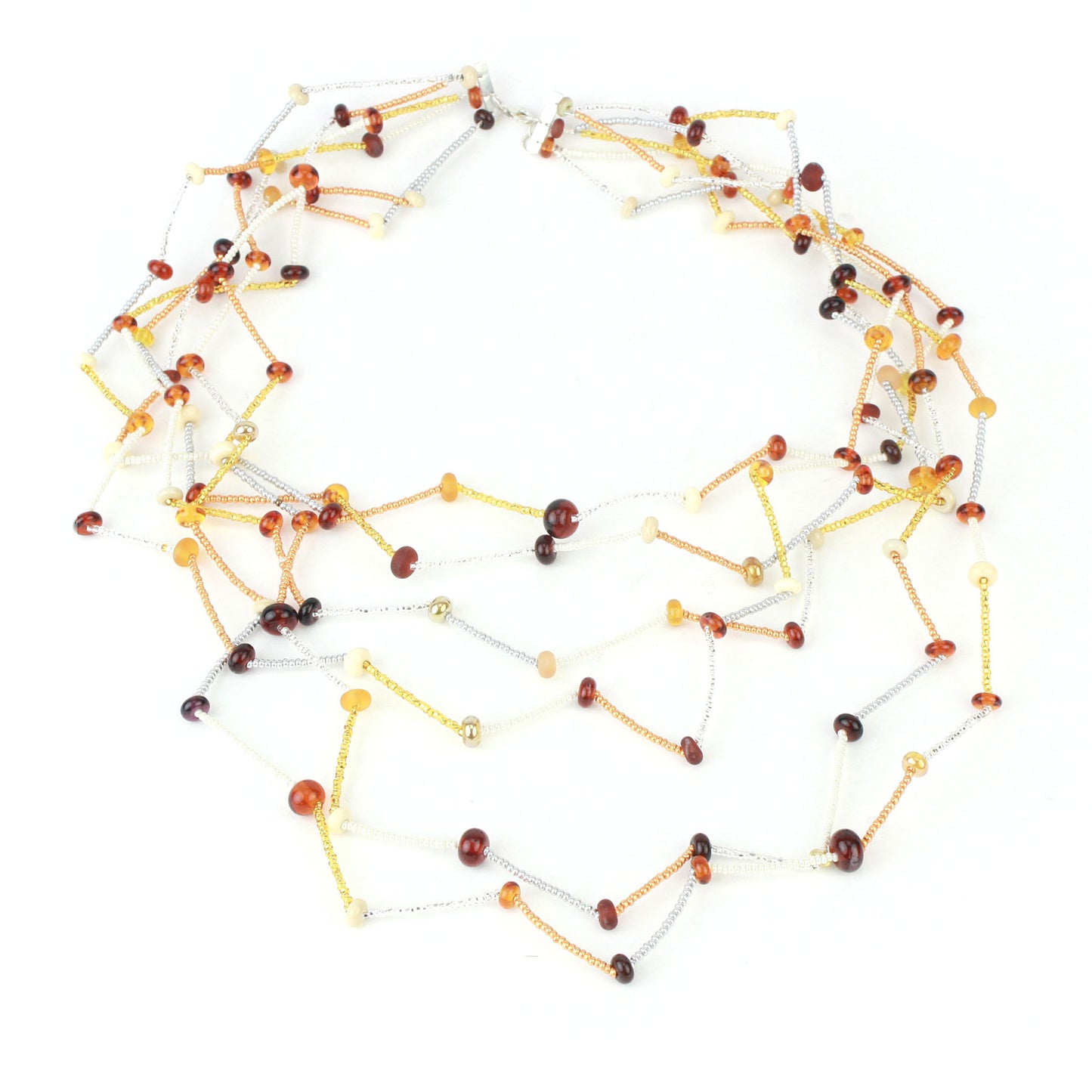 The Fiesta Necklace in amber, ivory and gold. Handcrafted six-strand necklace in amber, ivory, and gold glass beads with handmade lampwork accents and a zig-zag drape.