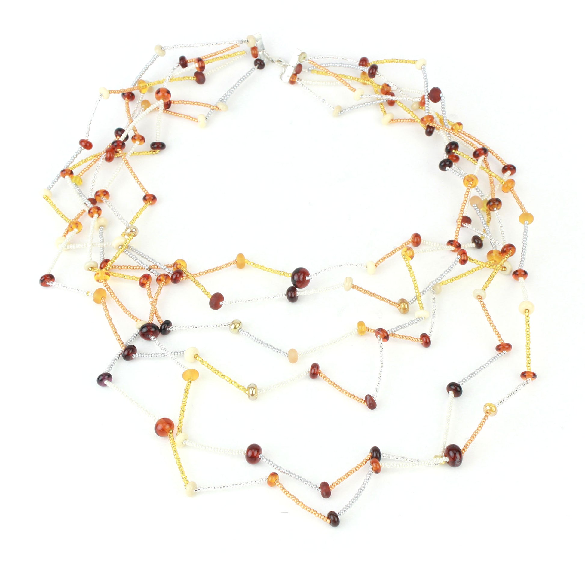 The Fiesta Necklace in amber, ivory and gold. Handcrafted six-strand necklace in amber, ivory, and gold glass beads with handmade lampwork accents and a zig-zag drape.