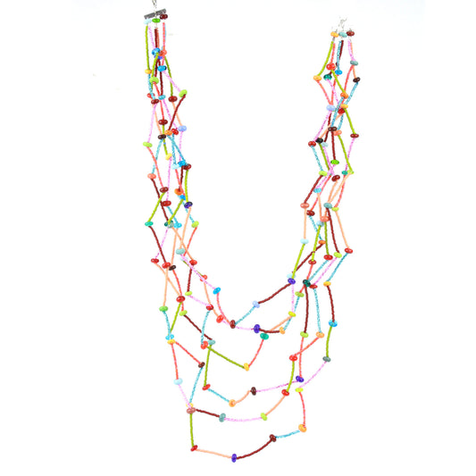 The Fiesta Necklace in multi color. Six-strand multicolor necklace with tiny glass and lampwork beads arranged in a crimped, zig-zag drape on steel cable.