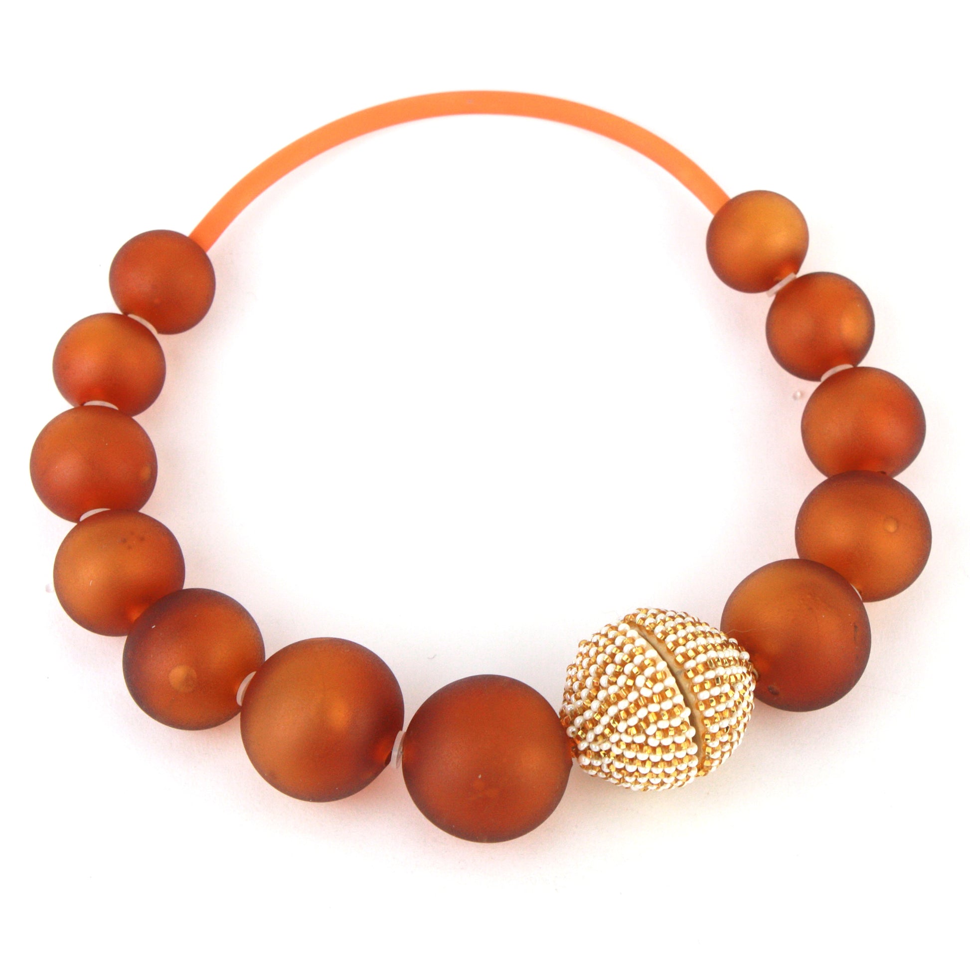 The Illumina Necklace, featuring handcrafted amber-hued glass beads and a beaded magnetic clasp, designed for effortless wear and timeless style.