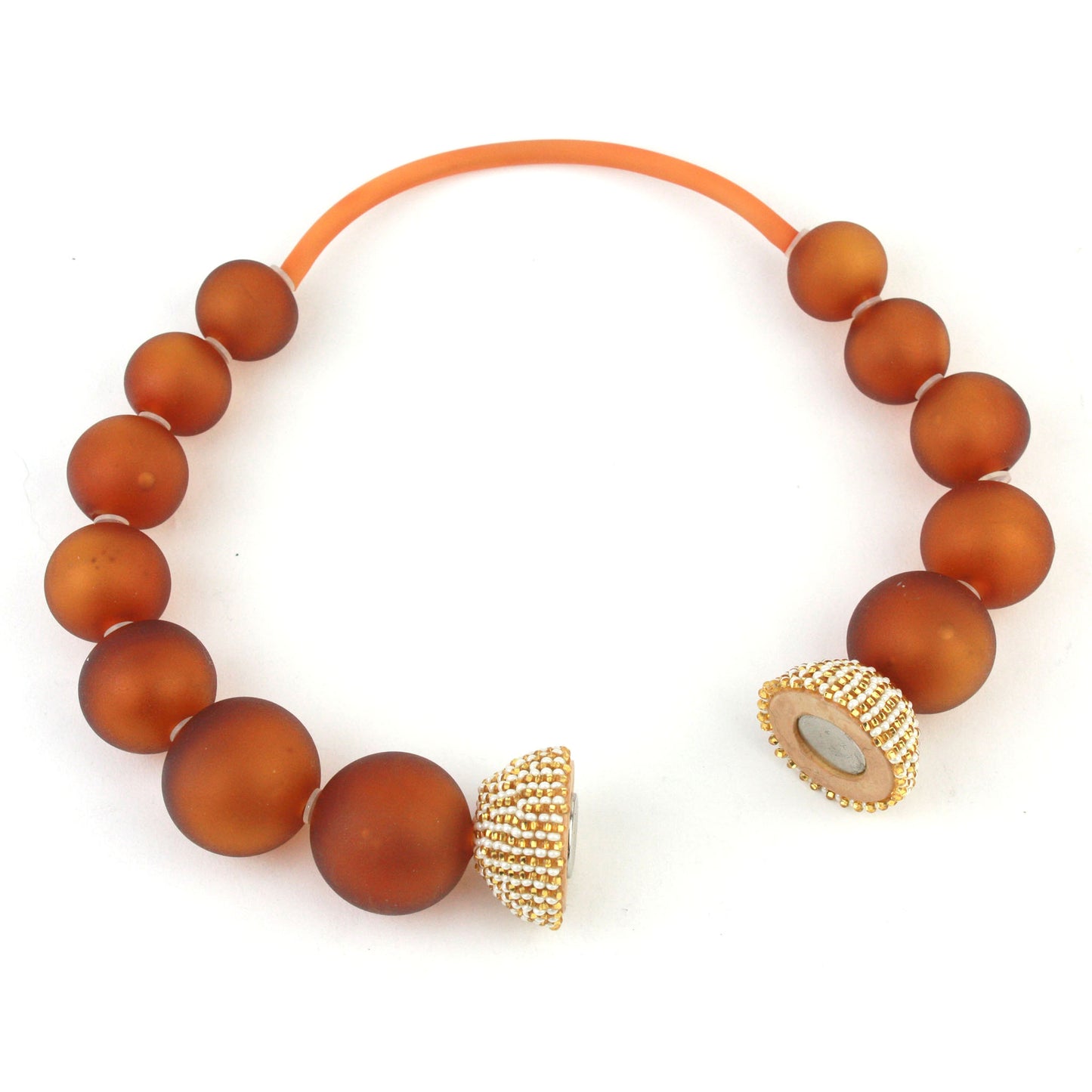 The Illumina Necklace, featuring handcrafted amber-hued glass beads and a beaded magnetic clasp, designed for effortless wear and timeless style.