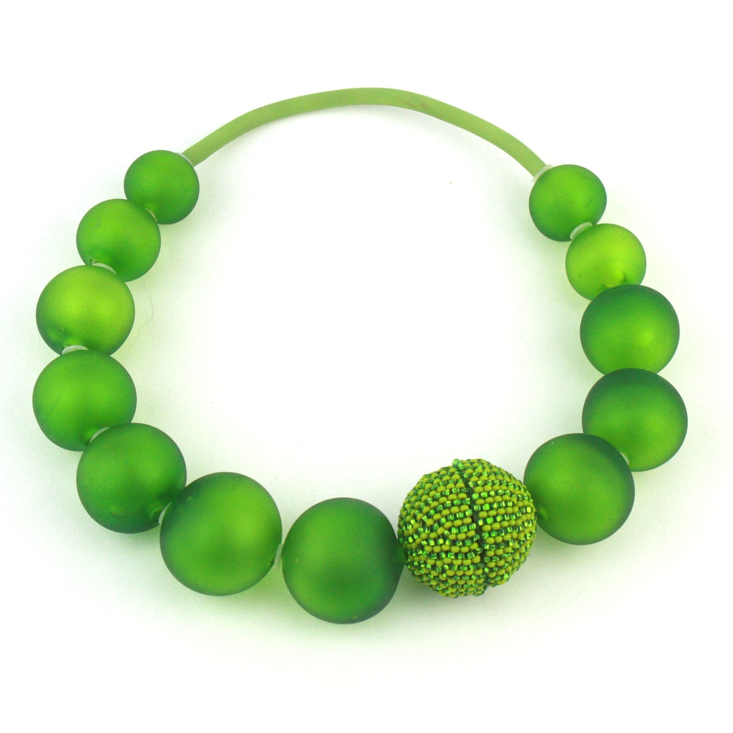 The Illumina Necklace in Spring Green, featuring handcrafted frosted glass beads and a beaded magnetic clasp, designed for effortless wear and bold elegance.