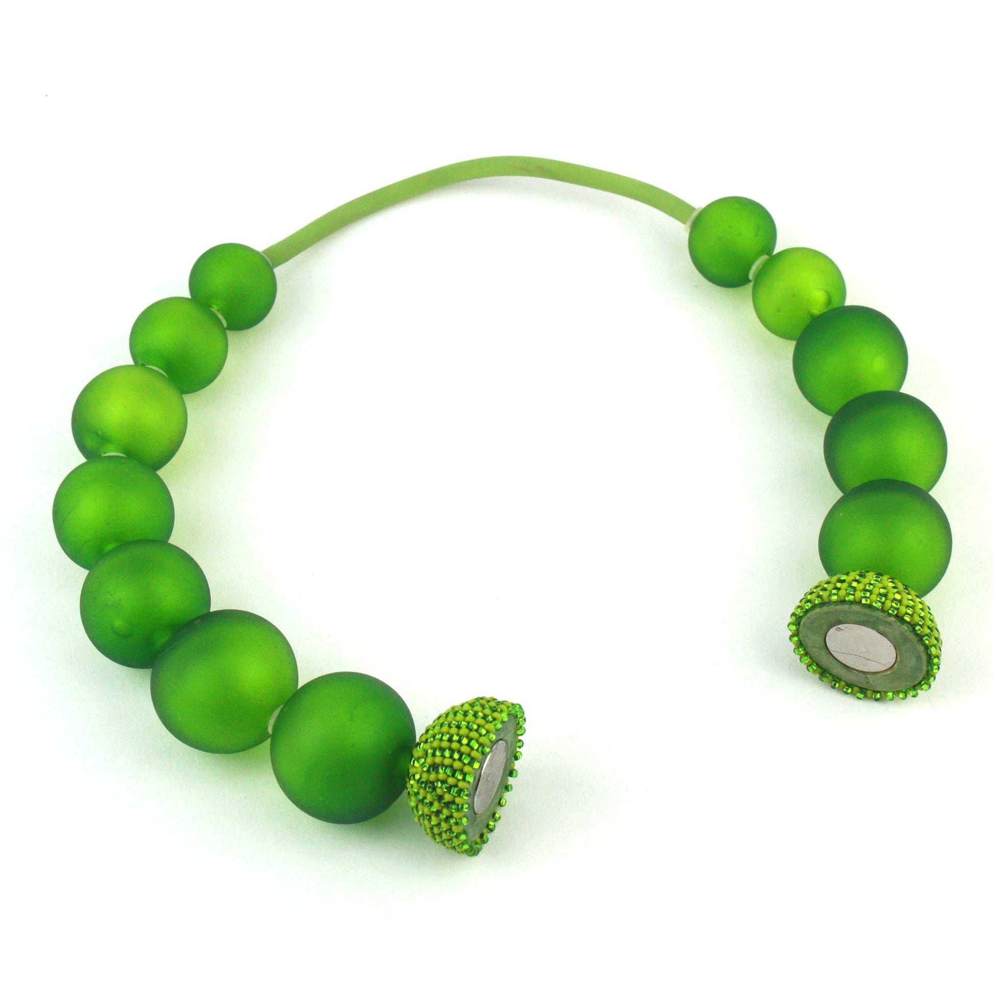 The Illumina Necklace in Spring Green, featuring handcrafted frosted glass beads and a beaded magnetic clasp, designed for effortless wear and bold elegance.