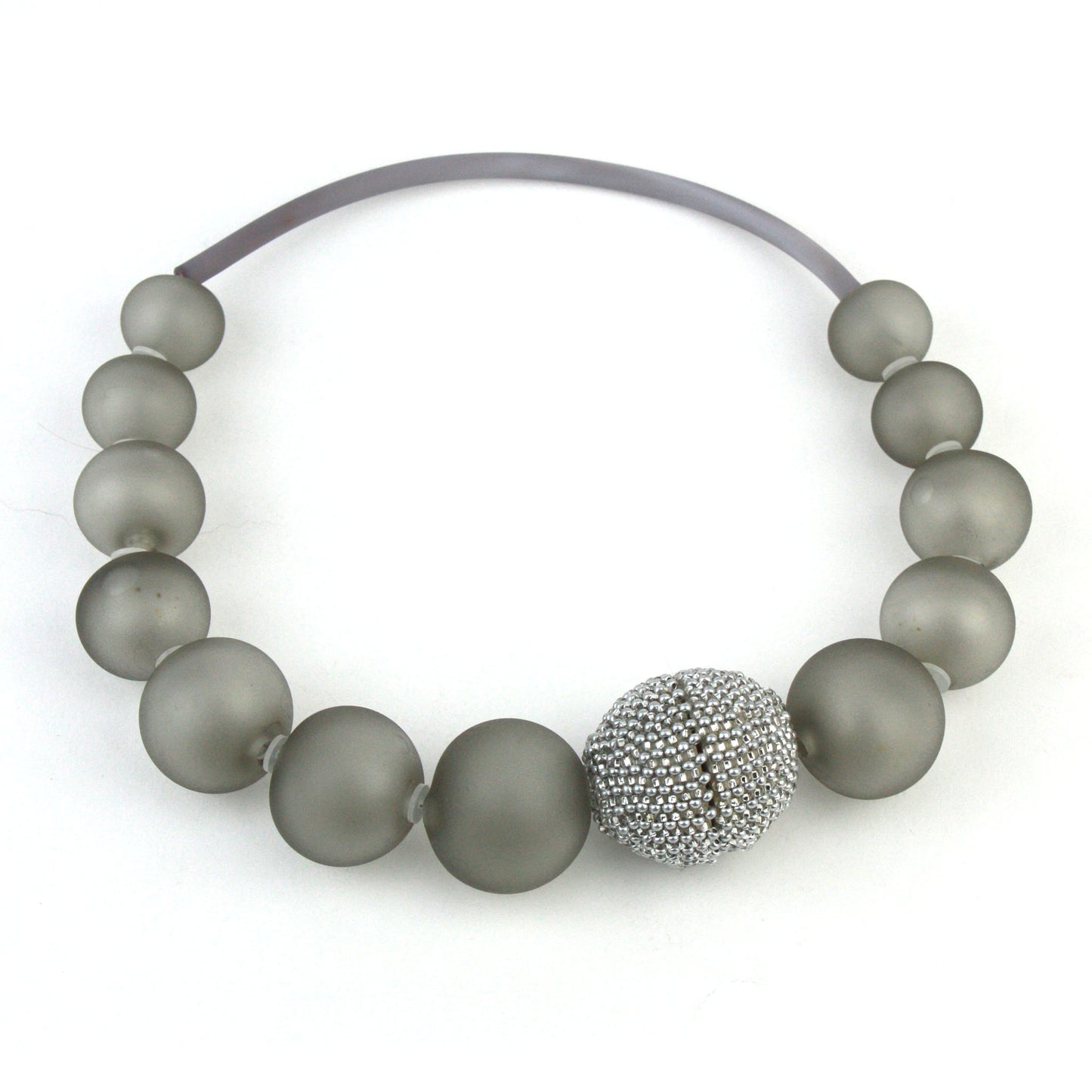 The Illumina Necklace in Grey, featuring handcrafted frosted glass beads and a beaded magnetic clasp, designed for effortless wear and timeless sophistication.