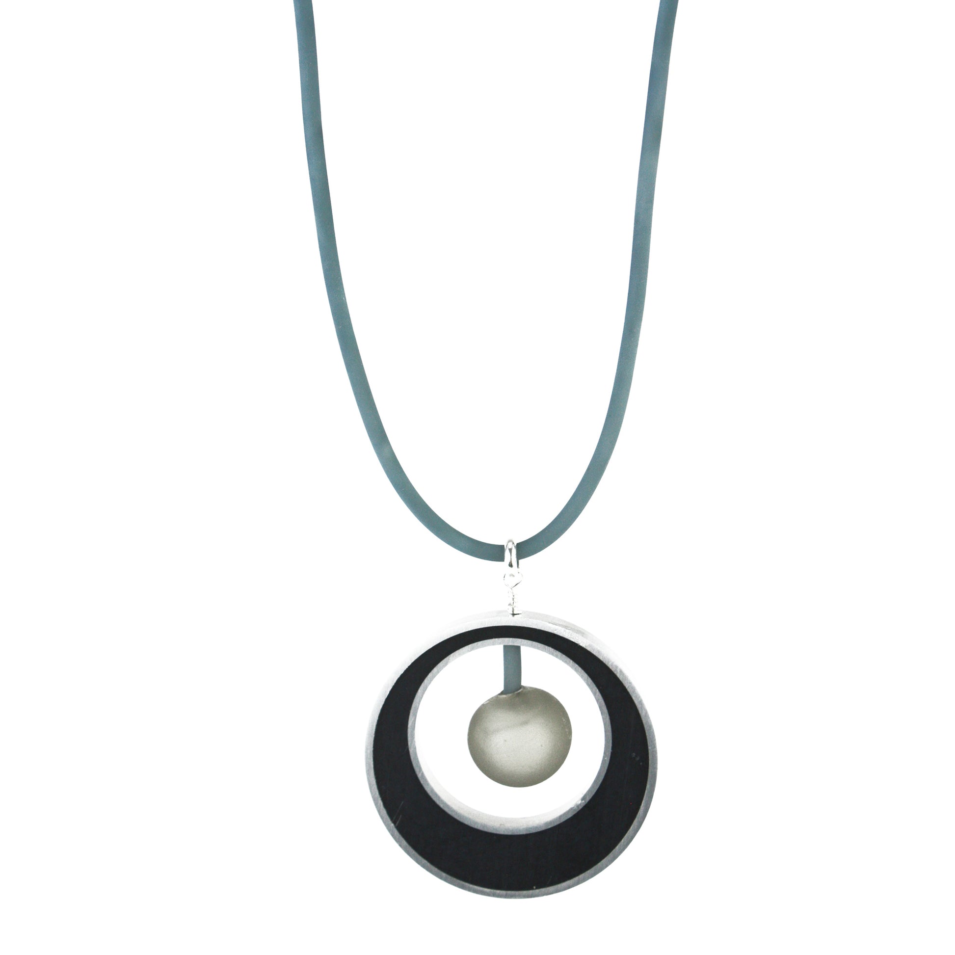 The Glory Necklace in Black & Grey, featuring a handcrafted pendant made from eco-resin, salvaged aluminum, and frosted blown glass, suspended on a fully adjustable silicone cord.