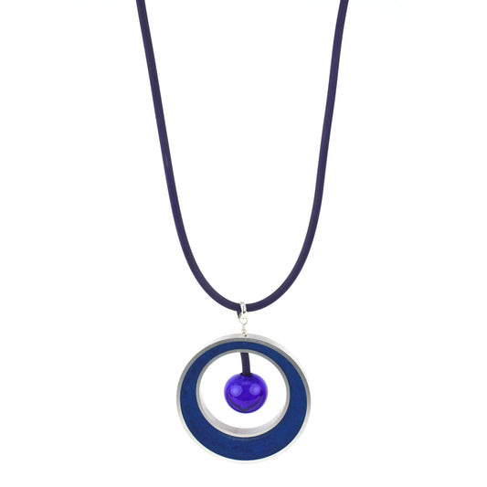 The Glory Necklace in Cobalt Blue, featuring a handcrafted pendant made from eco-resin, salvaged aluminum, and glossy blown glass, suspended on a fully adjustable silicone cord.