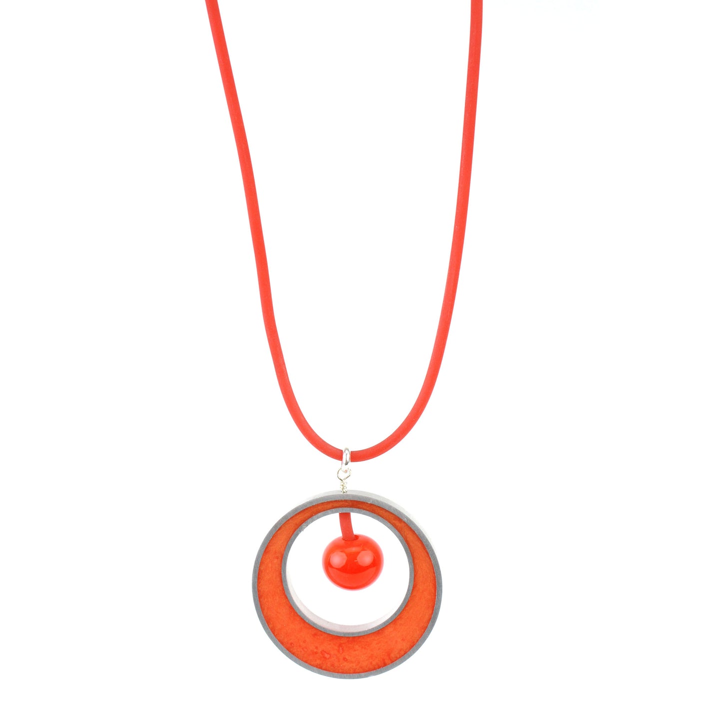 The Glory Necklace in Orange, featuring a handcrafted pendant made from eco-resin, salvaged aluminum, and glossy blown glass, suspended on a fully adjustable silicone cord.