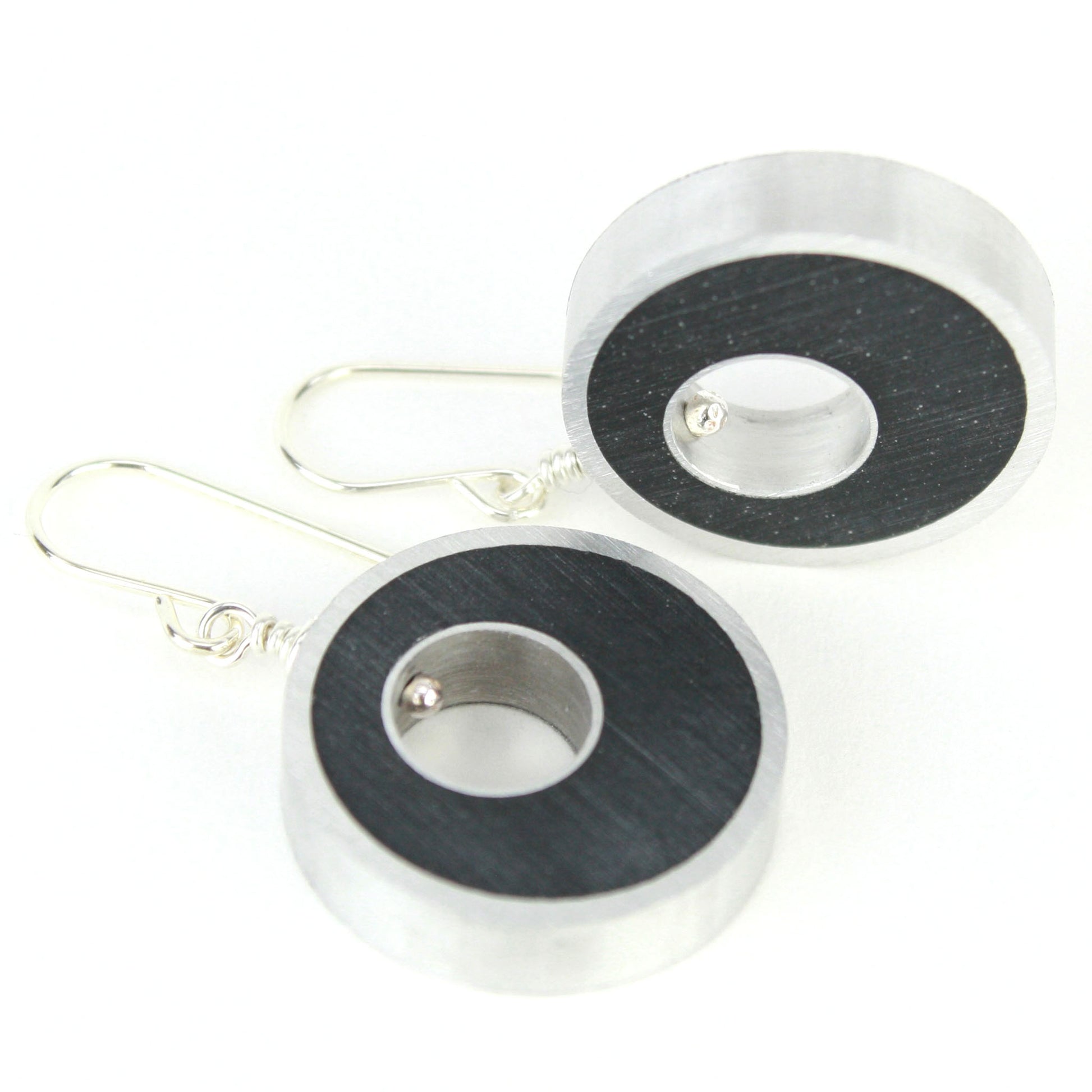 Black Spotlight Earrings made of eco-resin and salvaged aluminum with lightweight construction and sterling silver ear wires.