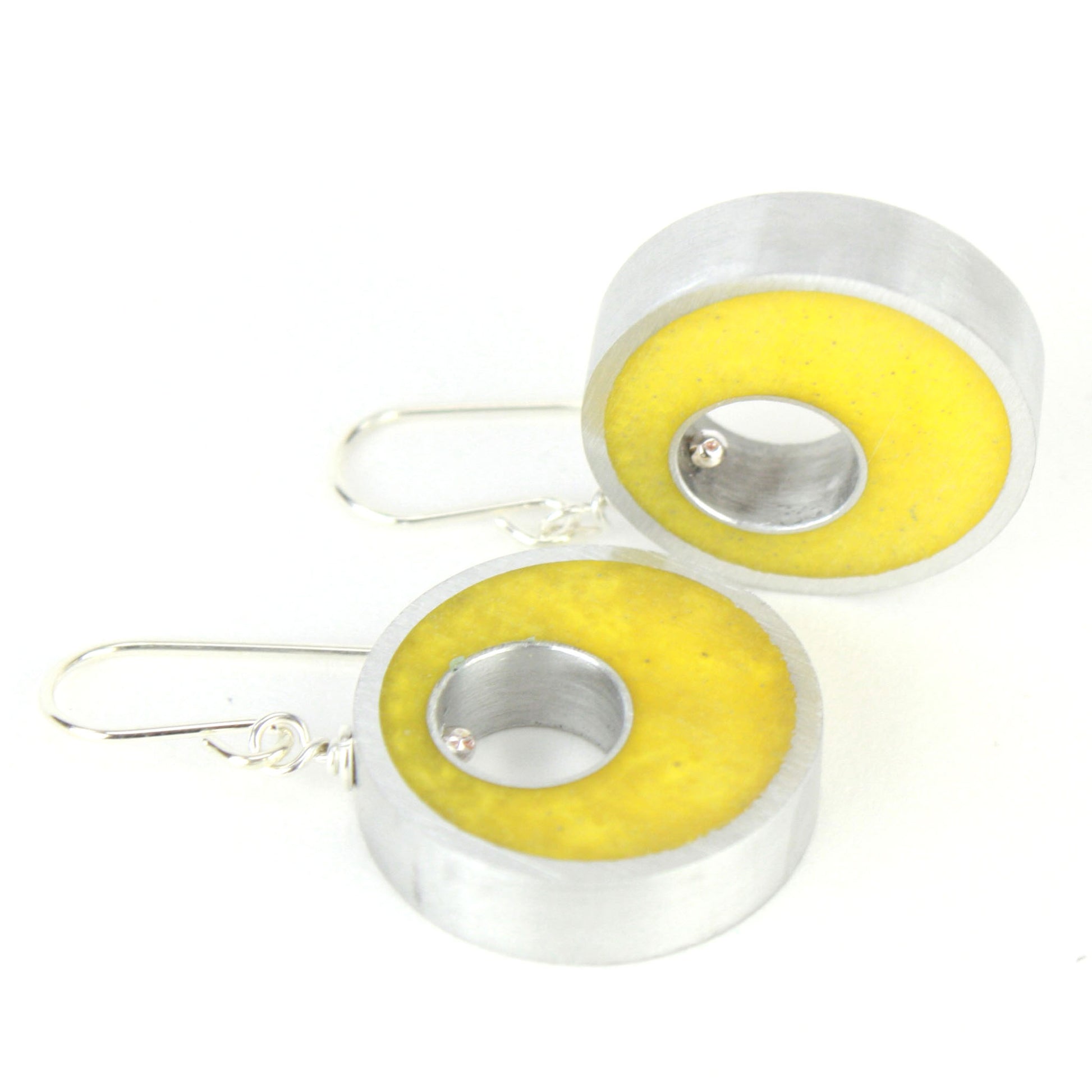 Yellow Spotlight Earrings made of eco-resin and salvaged aluminum with sterling silver ear wires, offering lightweight and sustainable brilliance.

