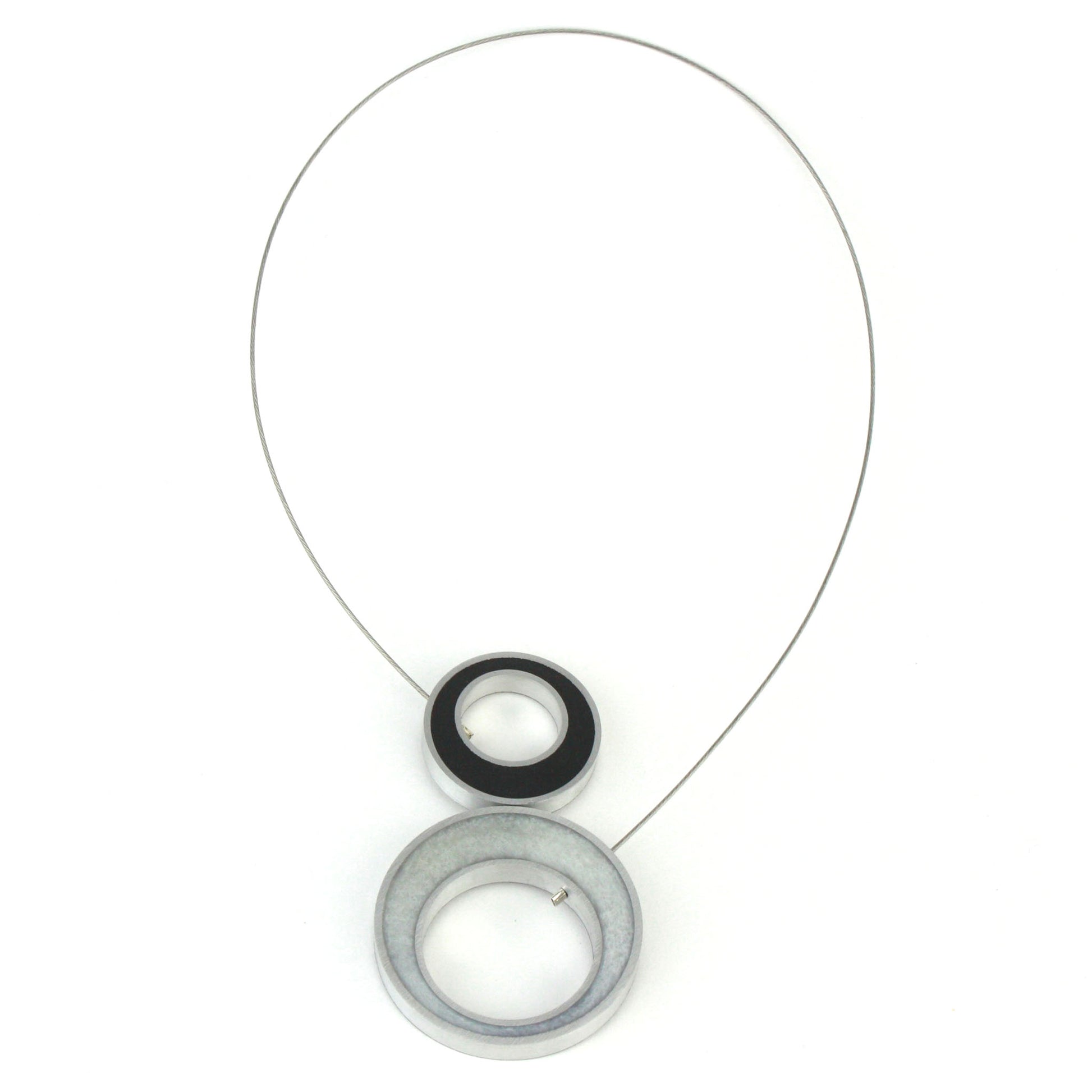 Reversible Duet Necklace featuring two color combinations, crafted from eco-resin and salvaged aluminum with a lightweight magnetic closure. Shown in Black and White combination.