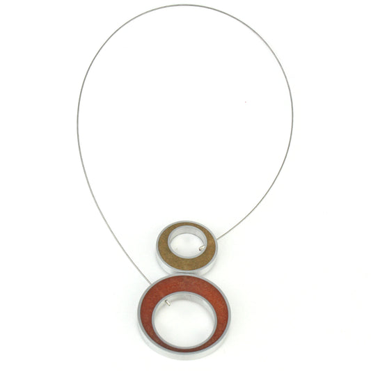 Reversible Duet Necklace featuring two color combinations, crafted from eco-resin and salvaged aluminum with a lightweight magnetic closure. Shown in gold and copper combination.