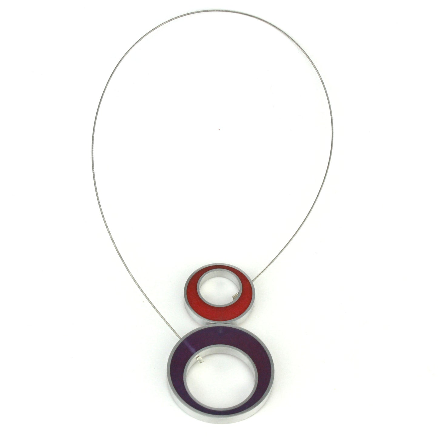 Reversible Duet Necklace featuring bold color combinations, made from eco-resin and salvaged aluminum with a magnetic front closure. Shown on the red and purple side.