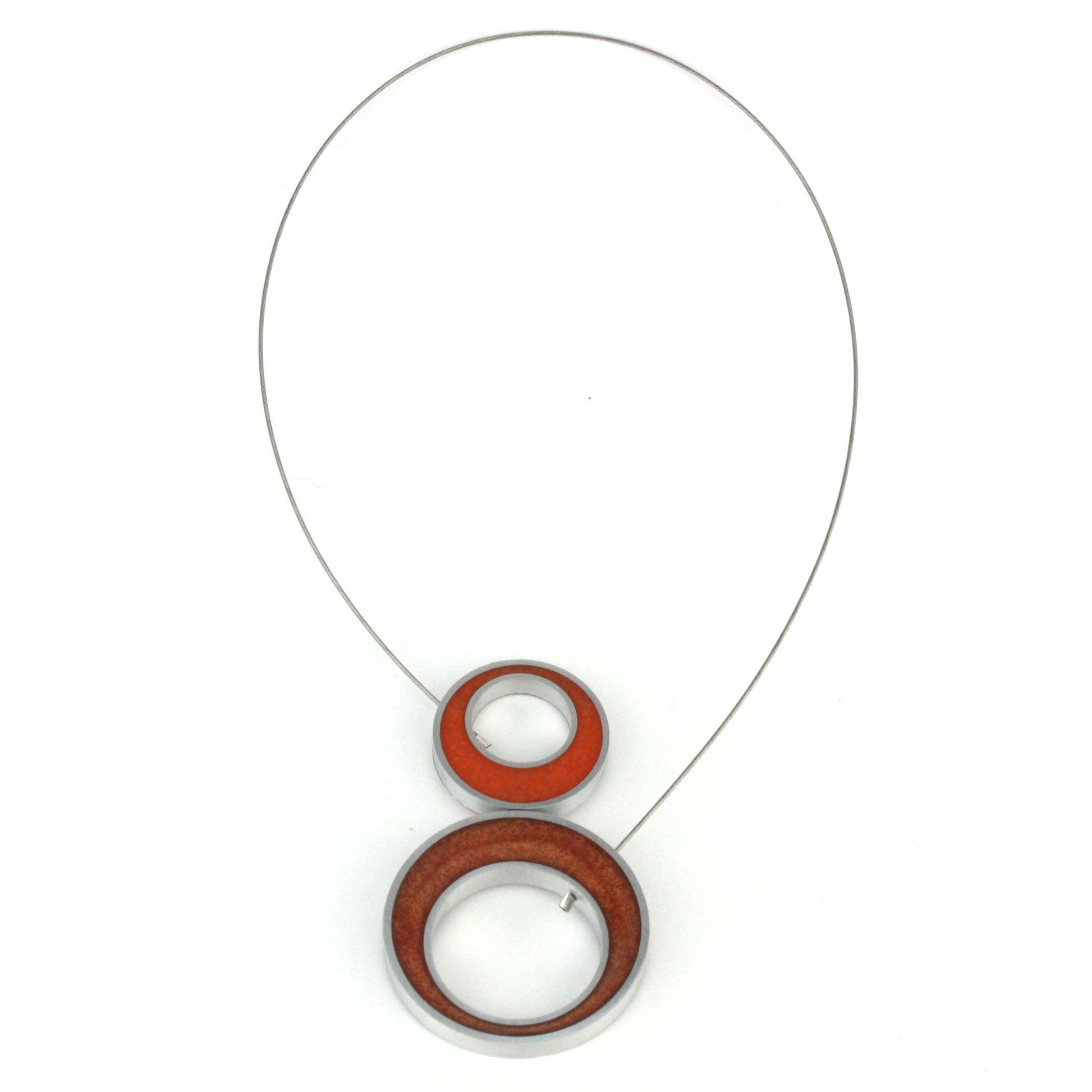 Reversible Duet Necklace featuring bold color combinations, made from eco-resin and salvaged aluminum with a magnetic front closure. Shown on the orange and copper side.