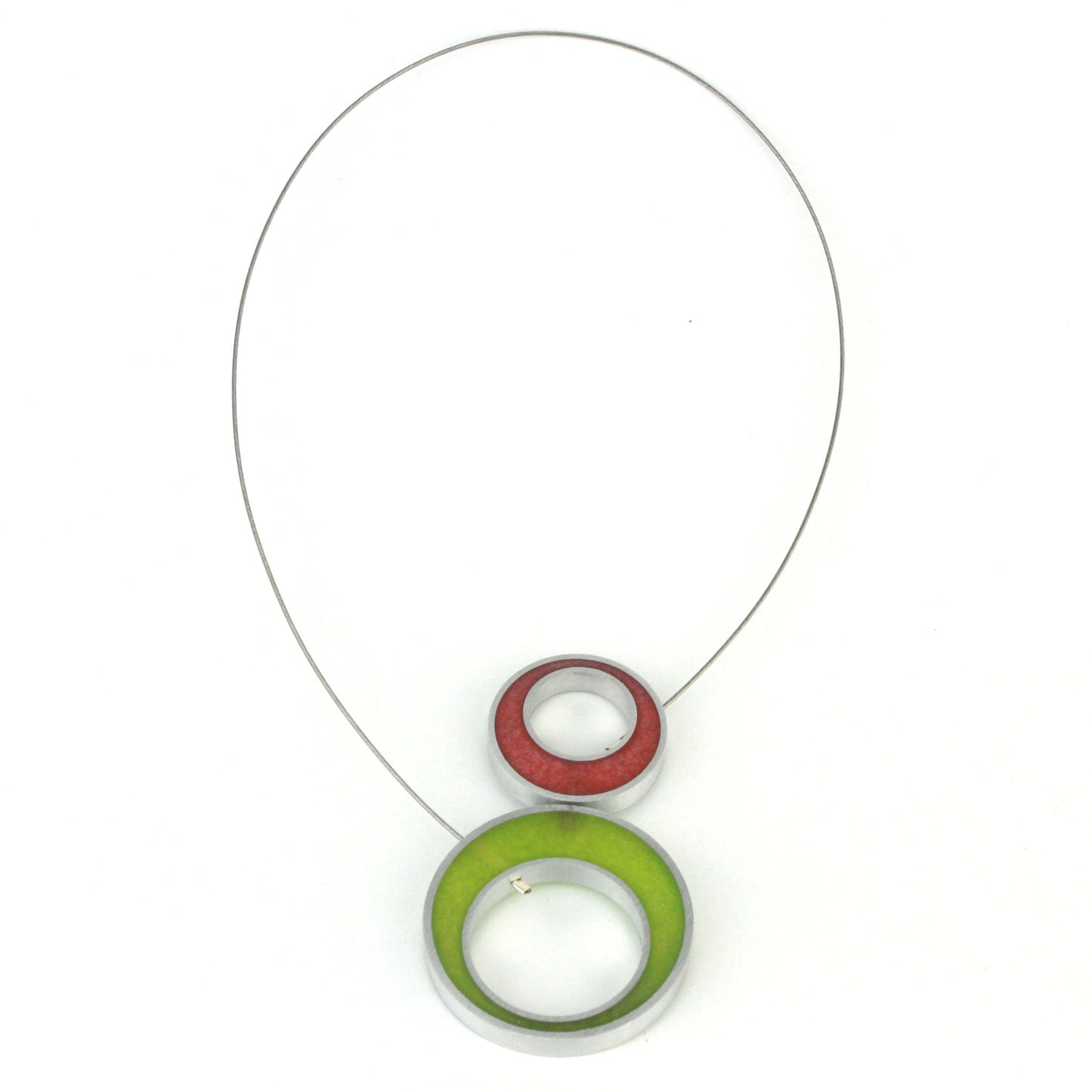 A reversible Duet Necklace featuring two color combinations, crafted from eco-resin and salvaged aluminum with a magnetic front closure.