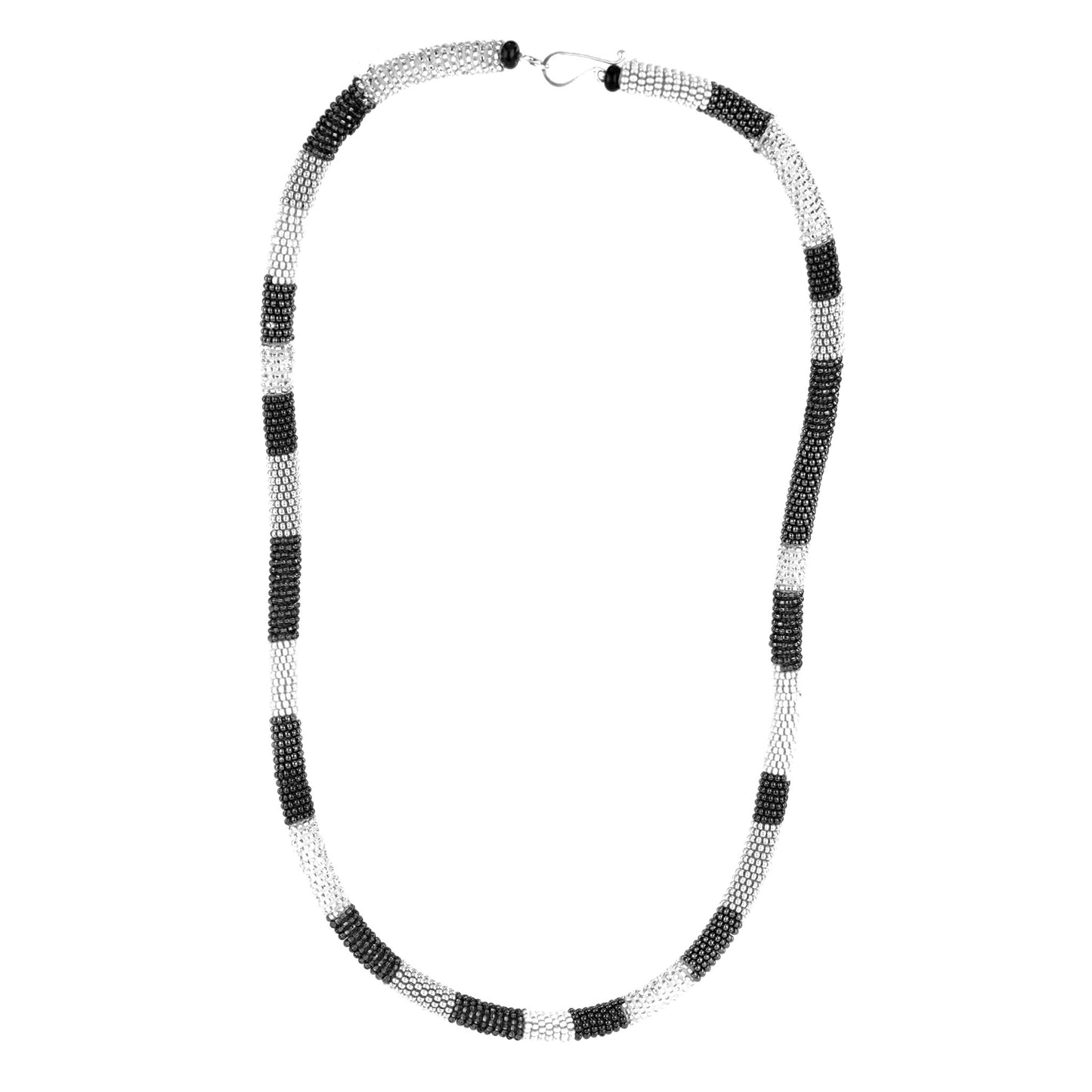 Confetti Knot Necklace in black, white, and silver glass beads on a silicone core, with a sterling silver hook-and-loop closure.