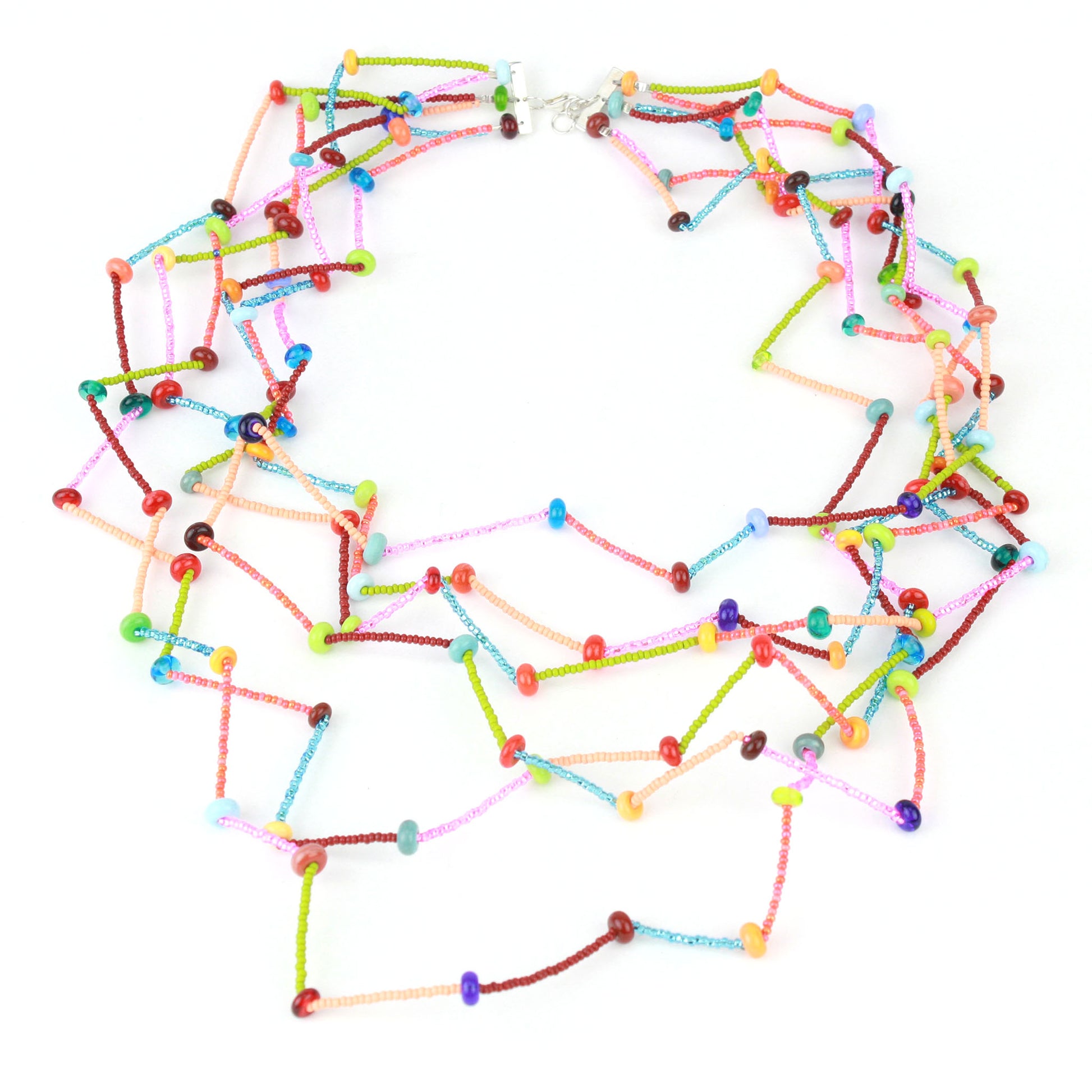 The Fiesta Necklace in multi color. Six-strand multicolor necklace with tiny glass and lampwork beads arranged in a crimped, zig-zag drape on steel cable.